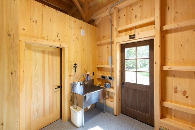 Spanish Cedar entry door on the right • Entrance to a half bathroom on the left