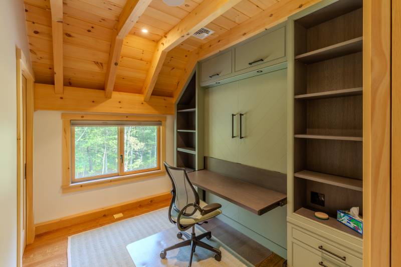The Murphy bed folds up to convert the bedroom into an office when not in use