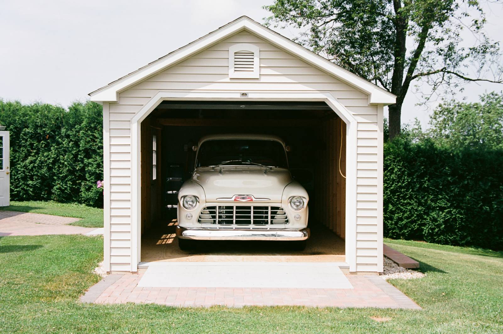 Front view of the single bay garage with garage door open