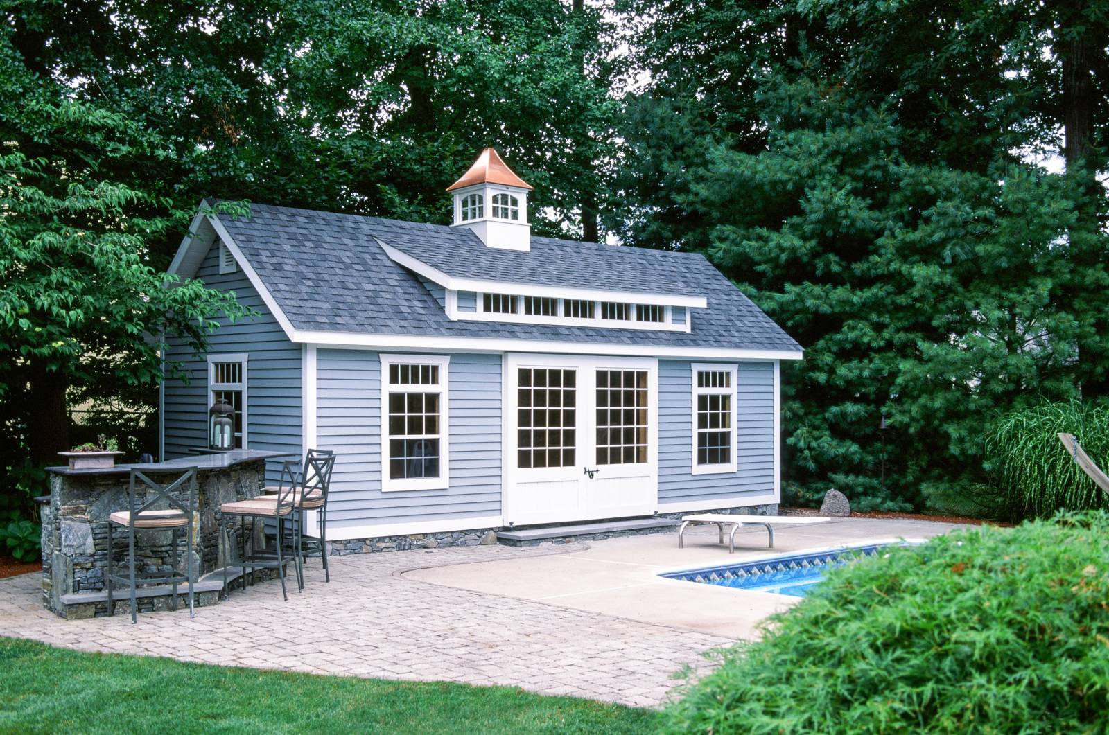 The pool house is integrated into the poolscape