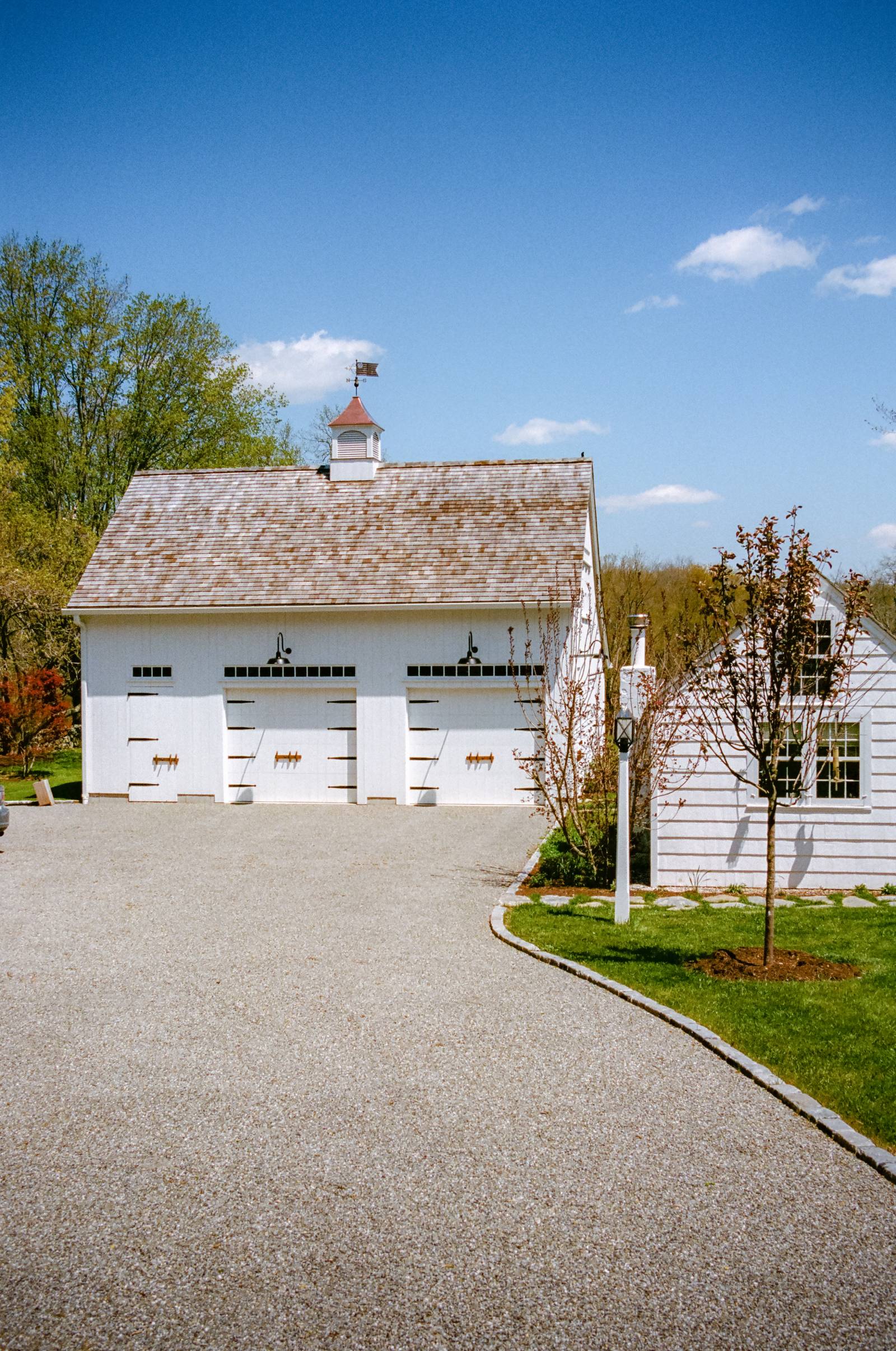 Approaching the garage via the stone driveway •Â notice the cedar shake roofing