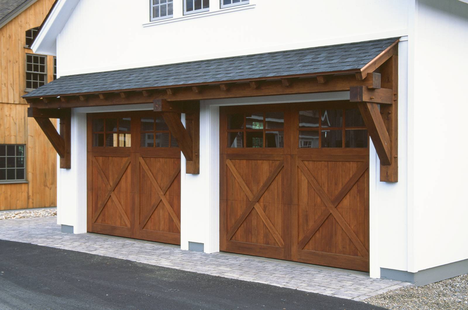 24' Big Sky Timber Frame Eyebrow Roof over two 10' x 8' Spanish Cedar Overhead Doors