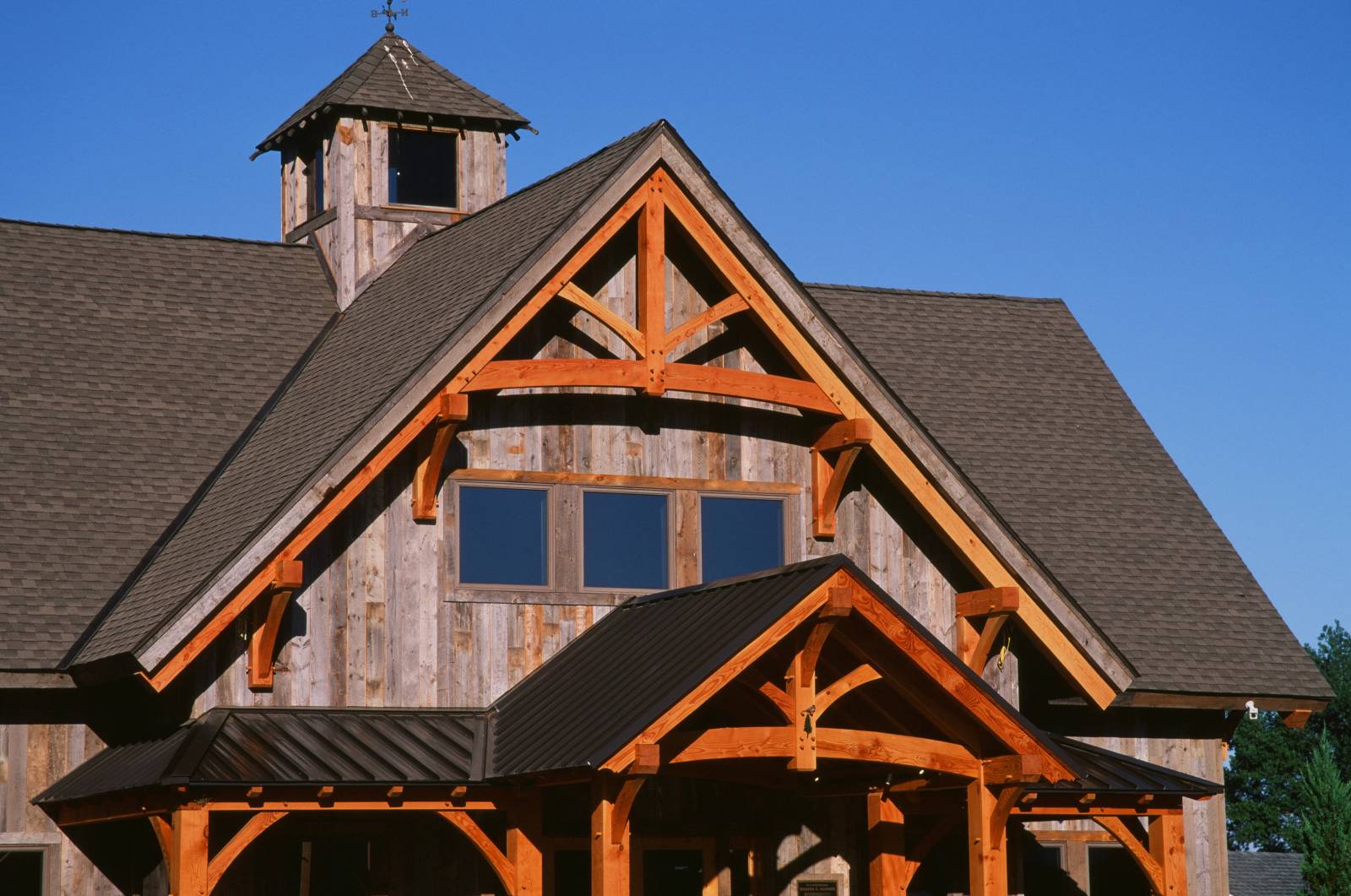 Huge Timber Frame Accents in the Gables of the Ellington Office - Notice the King Post Truss Design with Arched Bottom Chord