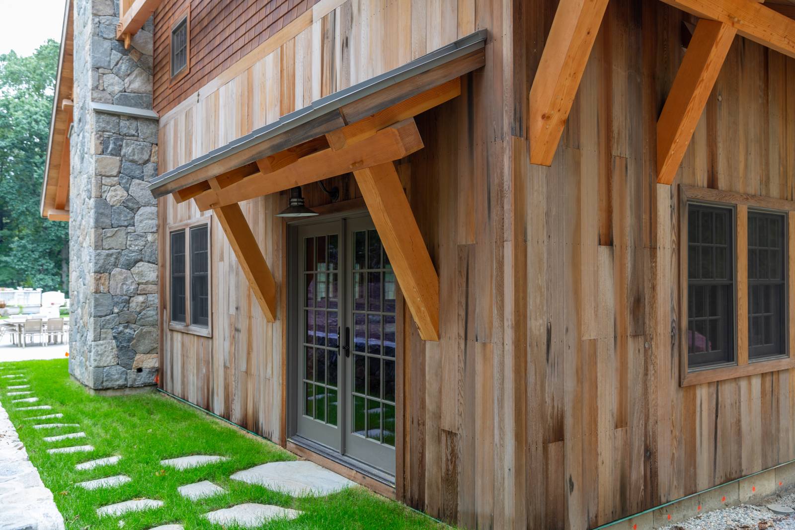 Custom Timber Frame Eyebrow Roof over Full View Glass Double Doors
