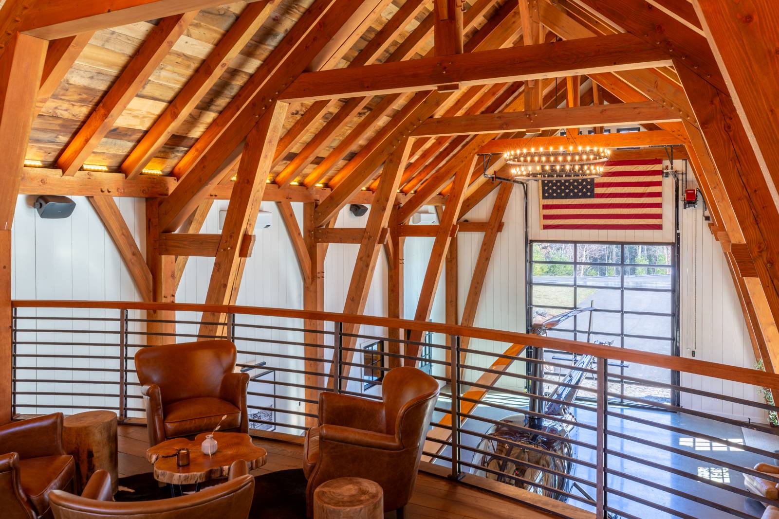Massive timbers and authentic joinery as seen from the seating area in the timber frame barn’s gallery style loft