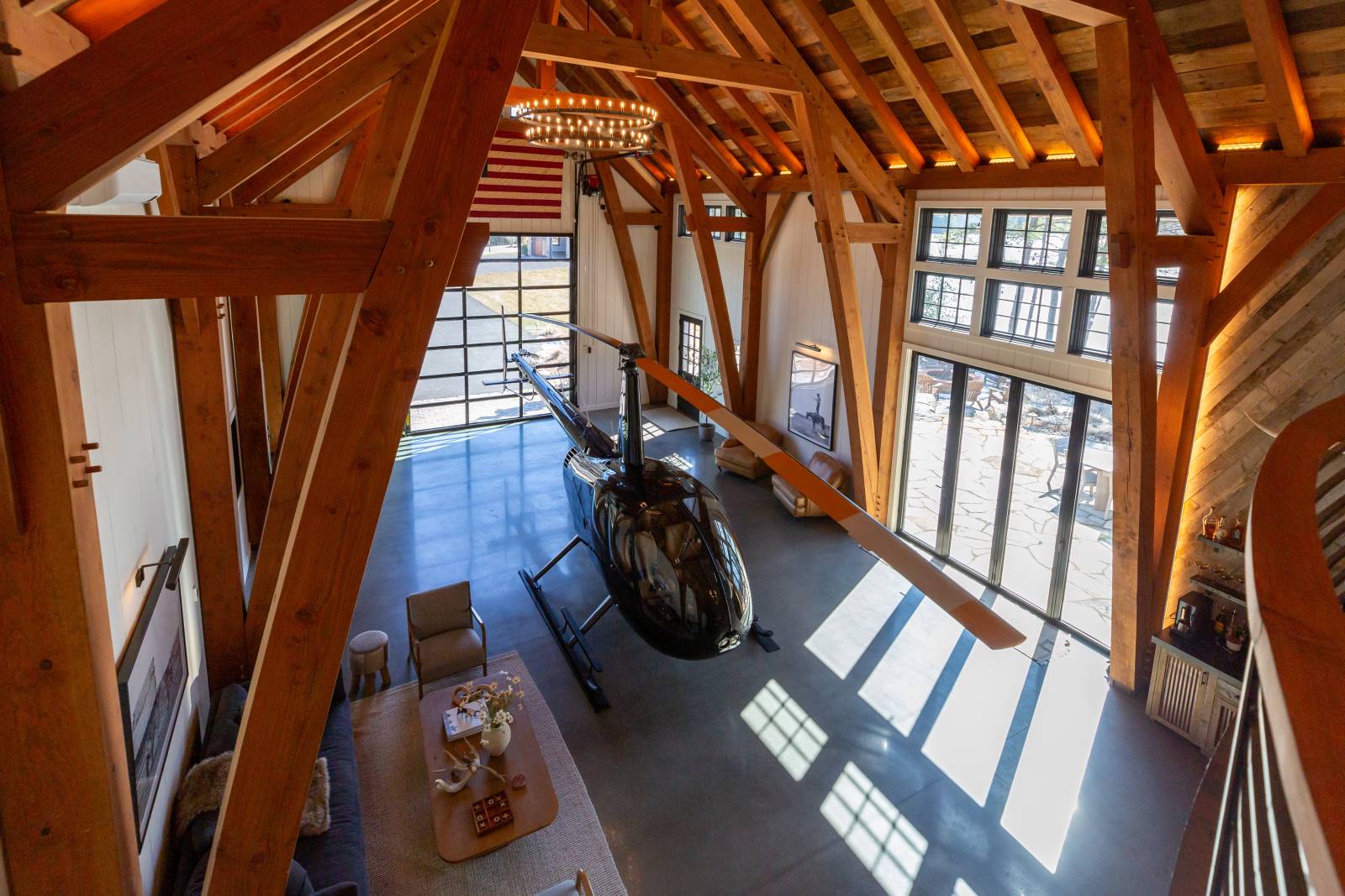 Another view of the helicopter from the loft • Tall windows and a glass overhead door let in natural light