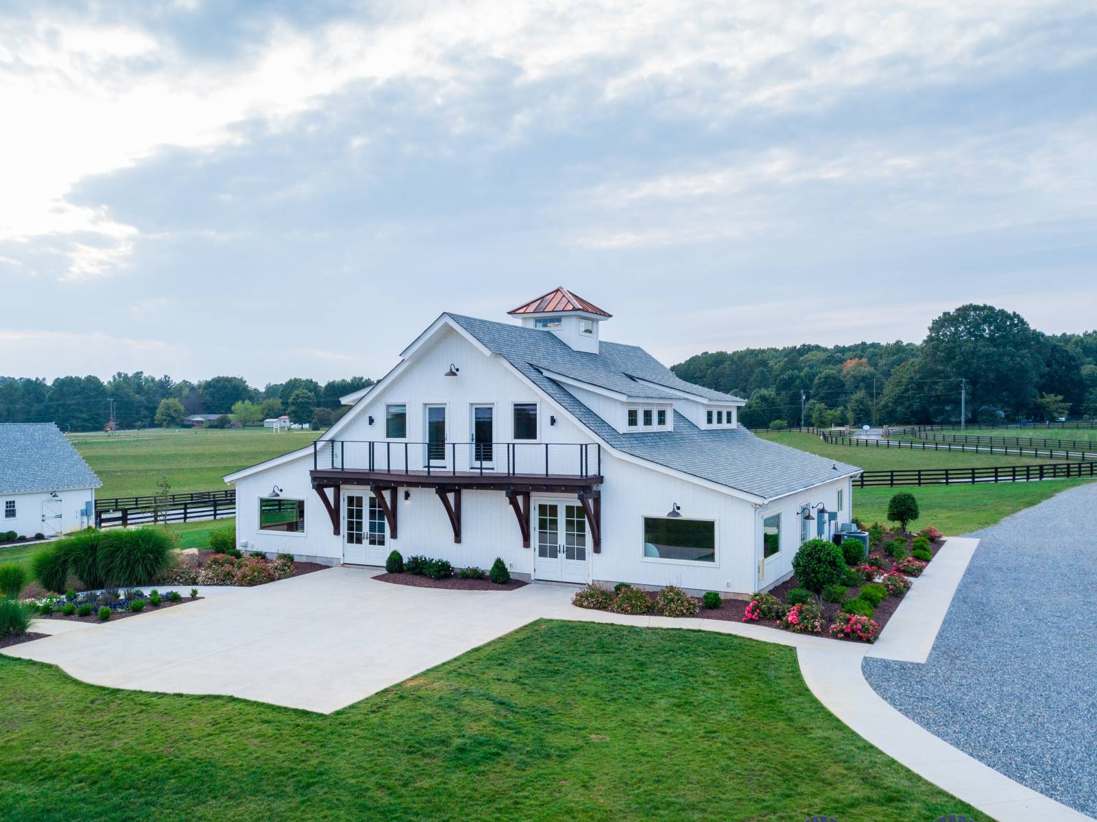 The second floor loft opens to a balcony, and double doors on the first floor lead to a patio