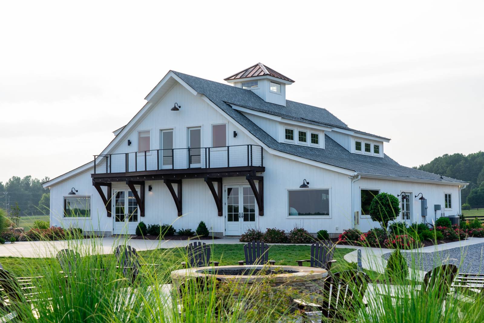 Timber frame cupola • Transom dormers • Balcony • Barn wedding venue