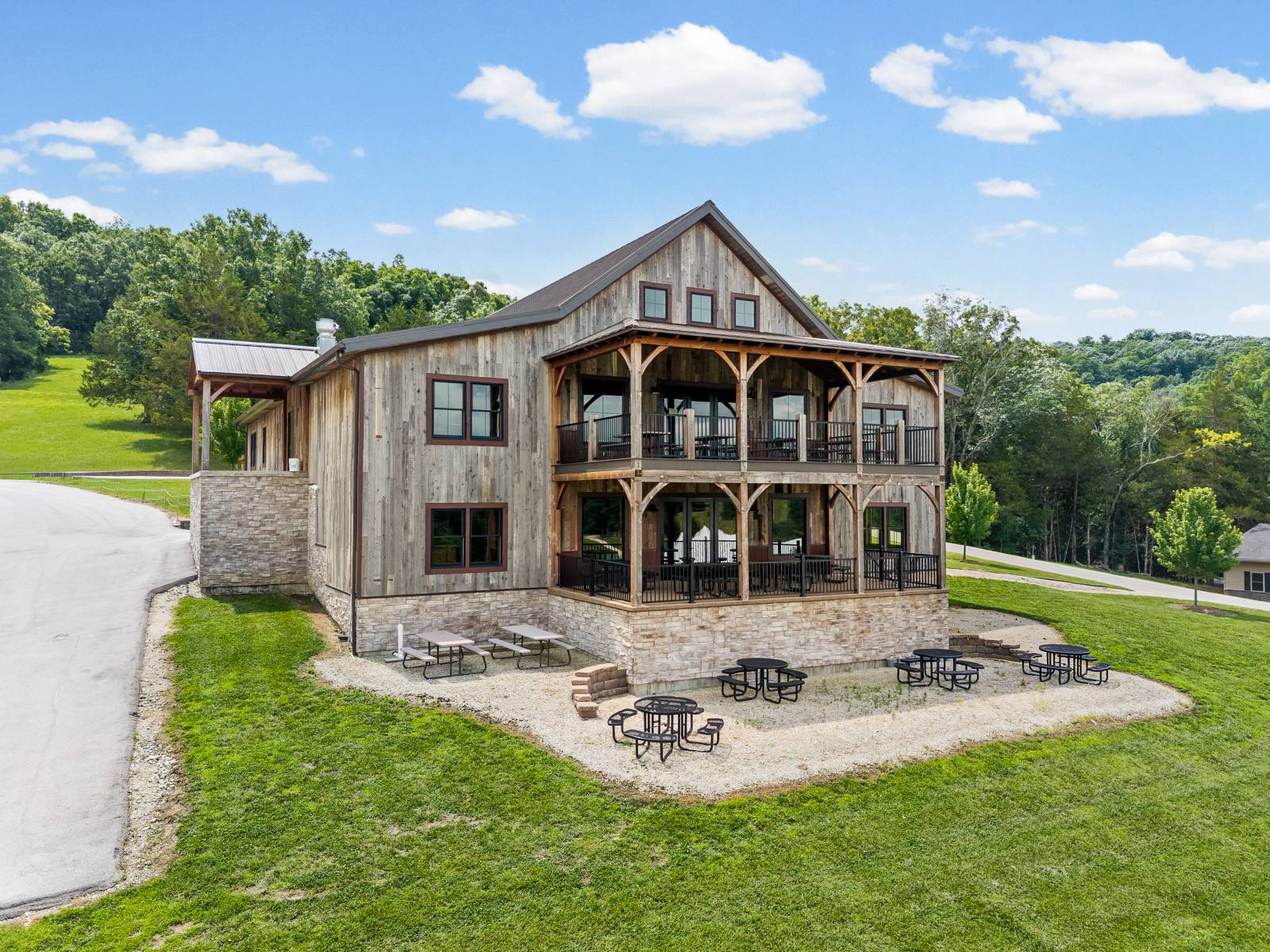 Timber frame overhangs cover the seating areas on the two-story timber frame deck