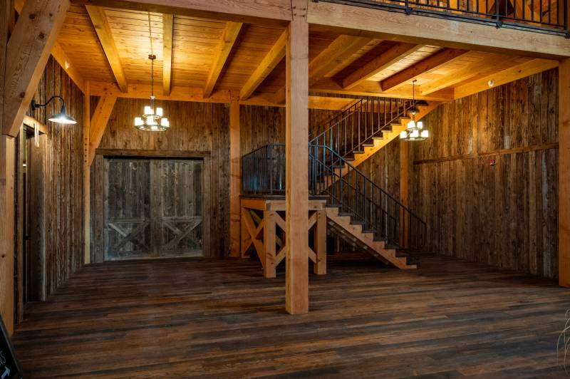 Timber Stairway • Dark Siding & Flooring Make the Douglas Fir Timbers Stand Out