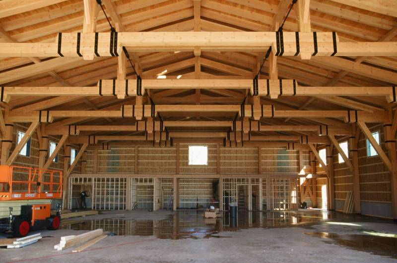 Building the mezzanine • Timber Frame Airplane Hanger interior