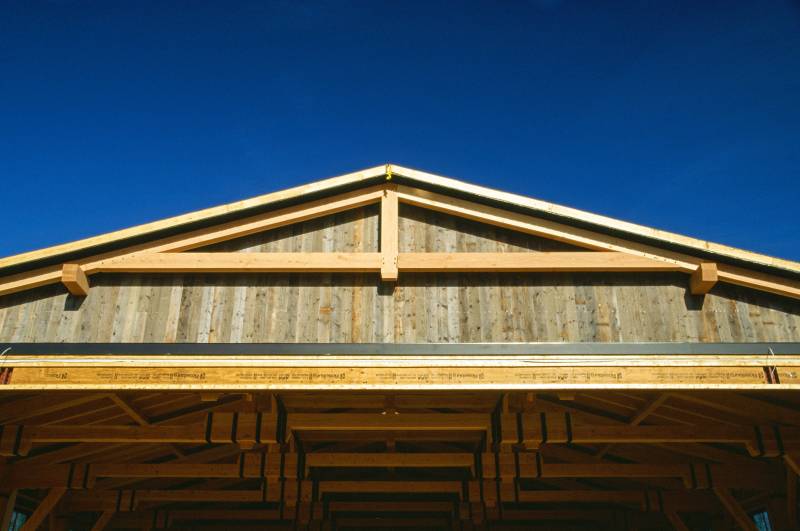 The front gable end with reclaimed barn board siding & truss accent