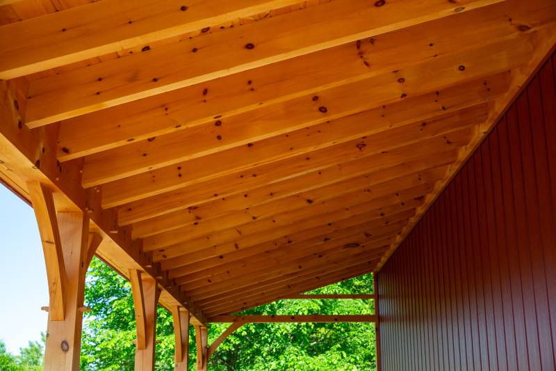 Underneath the timber frame lean-to • post & beam barn kit