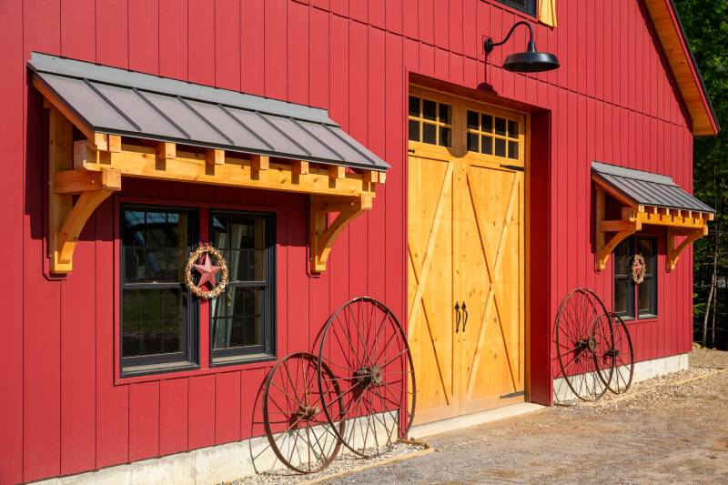 Two 8' timber frame eyebrow roofs • 10' x 12' pine faced overhead door • post & beam timber frame authentic barn