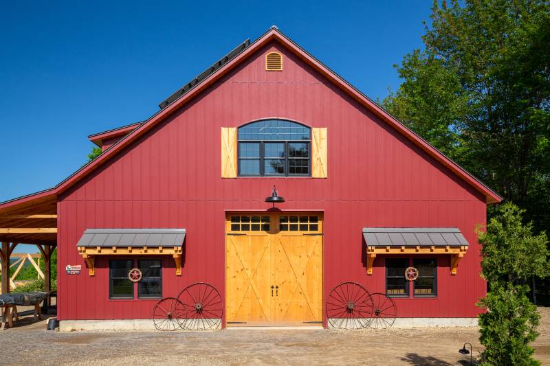 9-12 Roof Pitch • Barn Red Board & Batten Siding by Others • post & beam barn timber frame construction