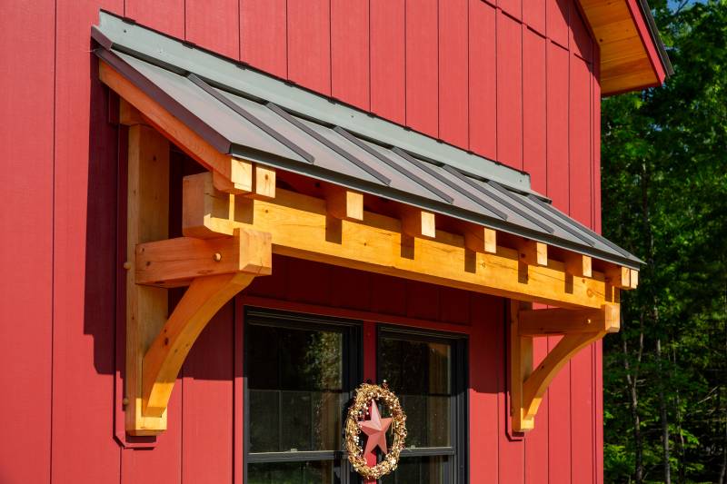 A closeup of the timber frame eyebrow roof • post & beam barn package