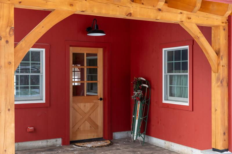 Open lean-to covers the patio • Custom family barn garage