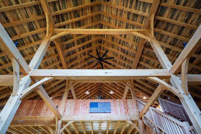 Looking up towards the loft • Post & beam barn with authentic timber frame construction