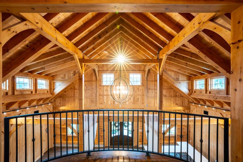 Looking over the balcony to the entrance • Timber frame barn wedding venue