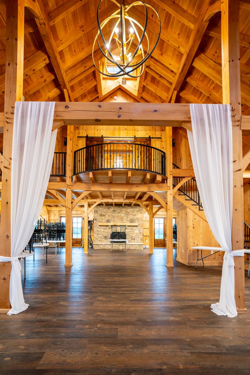 The fireplace, balcony, and chandelier against the post & beam interior make a great impression on guests