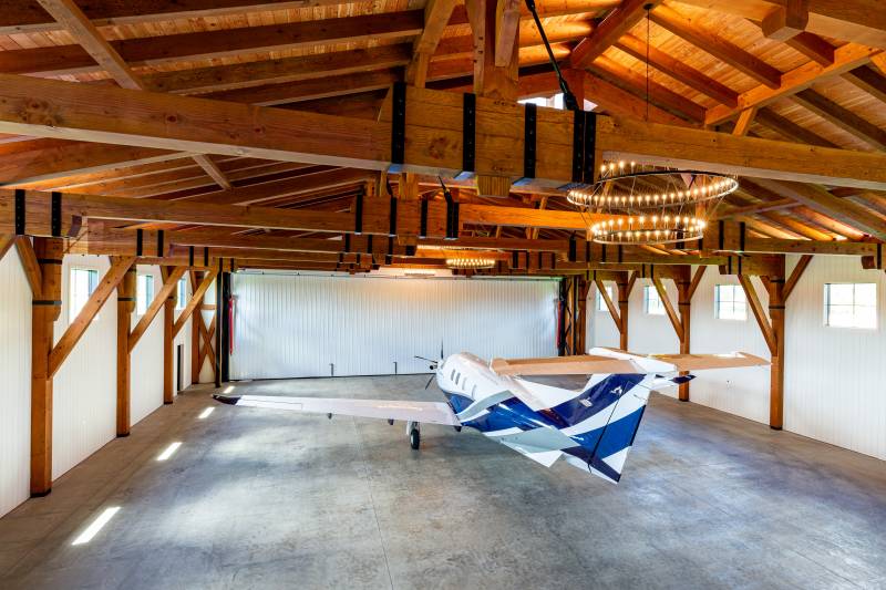 Douglas fir timbers stand out against the white shiplap walls