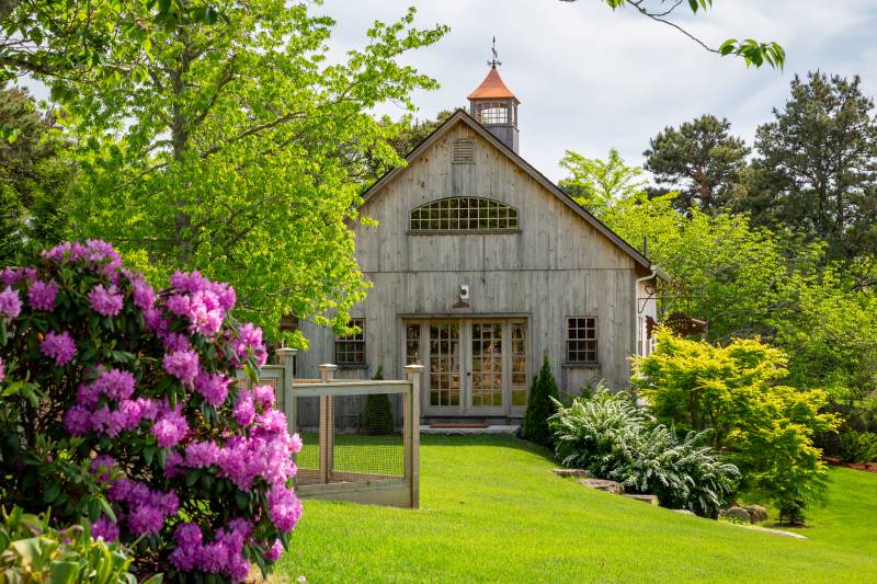 Naturally weathered pine siding brings coastal charm to the post & beam barn