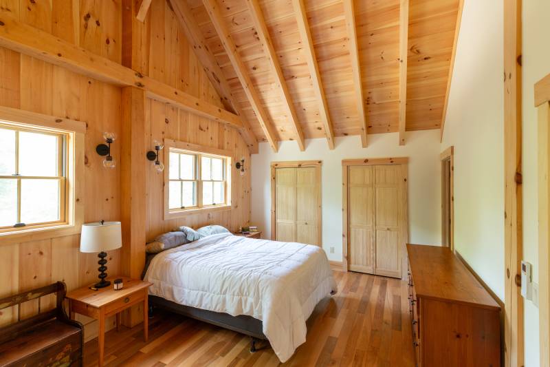 The bedroom in the barn home’s second floor loft