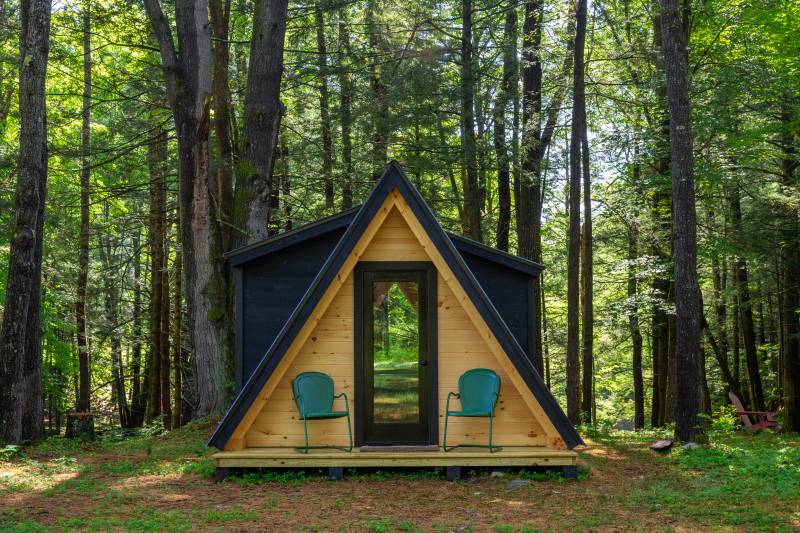 The A-Frame cabin has two shed dormers: one on either side
