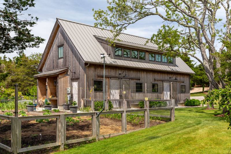 The landscaping around the 24' x 48' Plymouth Carriage Barn is well thought out