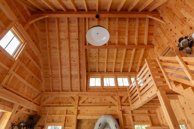 Looking up at the timber frame rafters within the post & beam barn