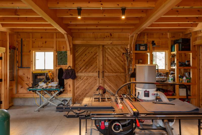 Interior of the split sliding door with herringbone pattern • Clear-span Douglas Fir beams