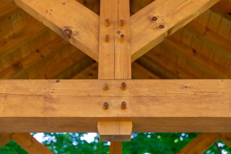 A closeup of the joinery within a king post truss