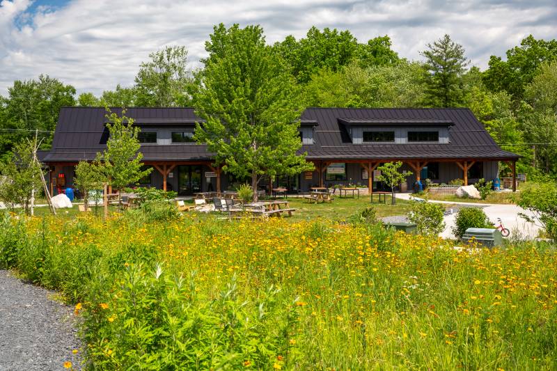The timber frame community center is immersed in nature